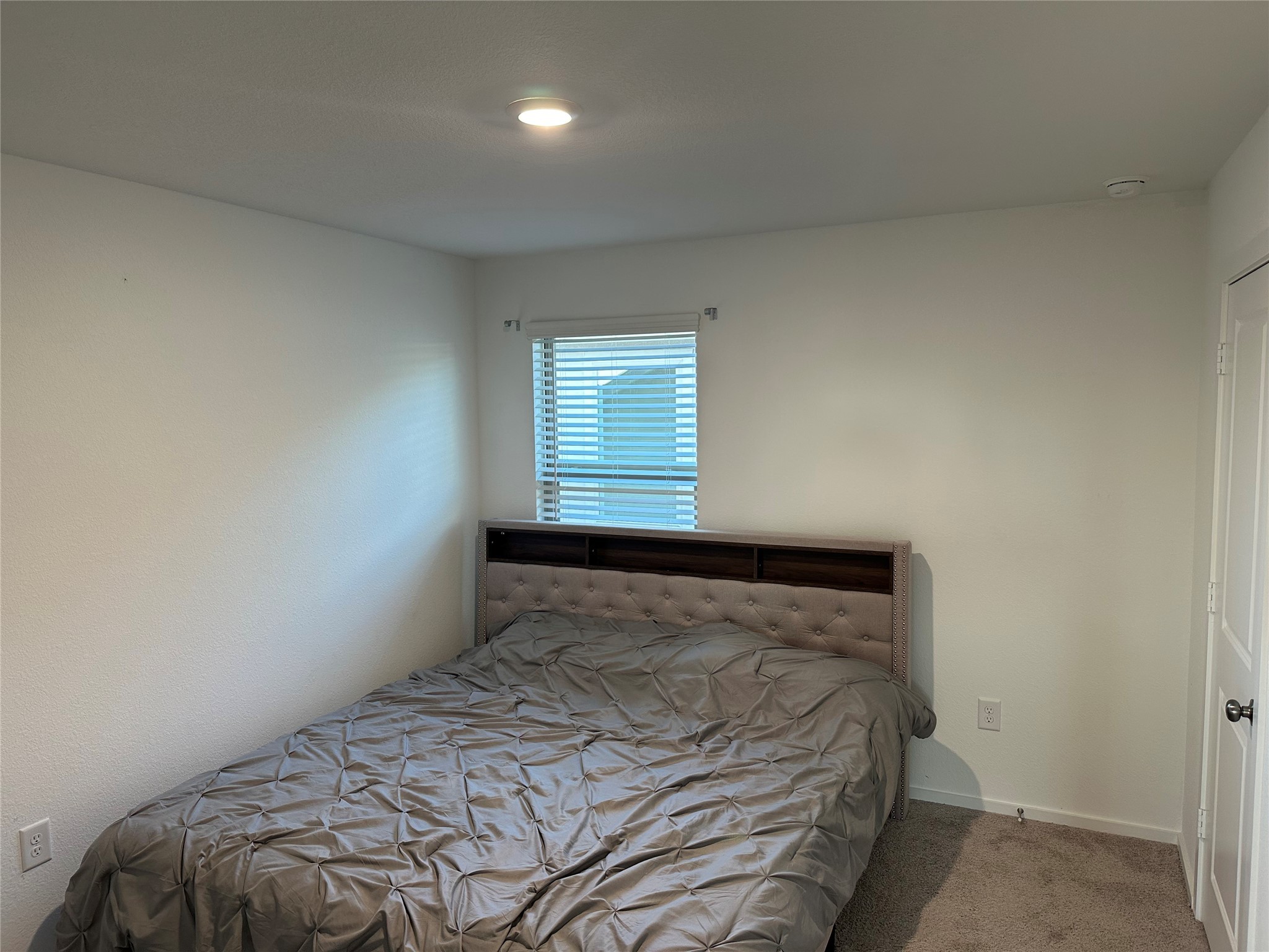 16936 Juniper Blossom Bend Conroe, TX 77302 - Photo 21 of 28 a bedroom with a bed and a window