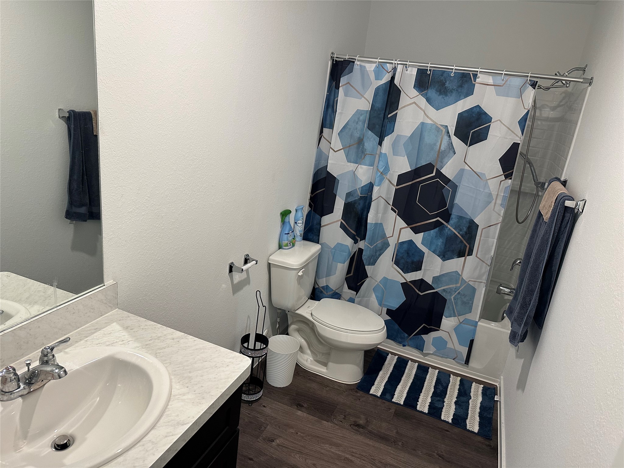 16936 Juniper Blossom Bend Conroe, TX 77302 - Photo 22 of 28 a bathroom with a sink and mirror with toilet