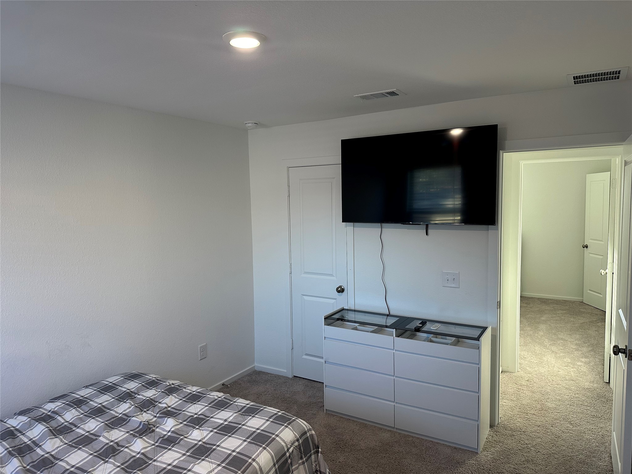 16936 Juniper Blossom Bend Conroe, TX 77302 - Photo 24 of 28 a living room with a flat screen tv a rug and a sink
