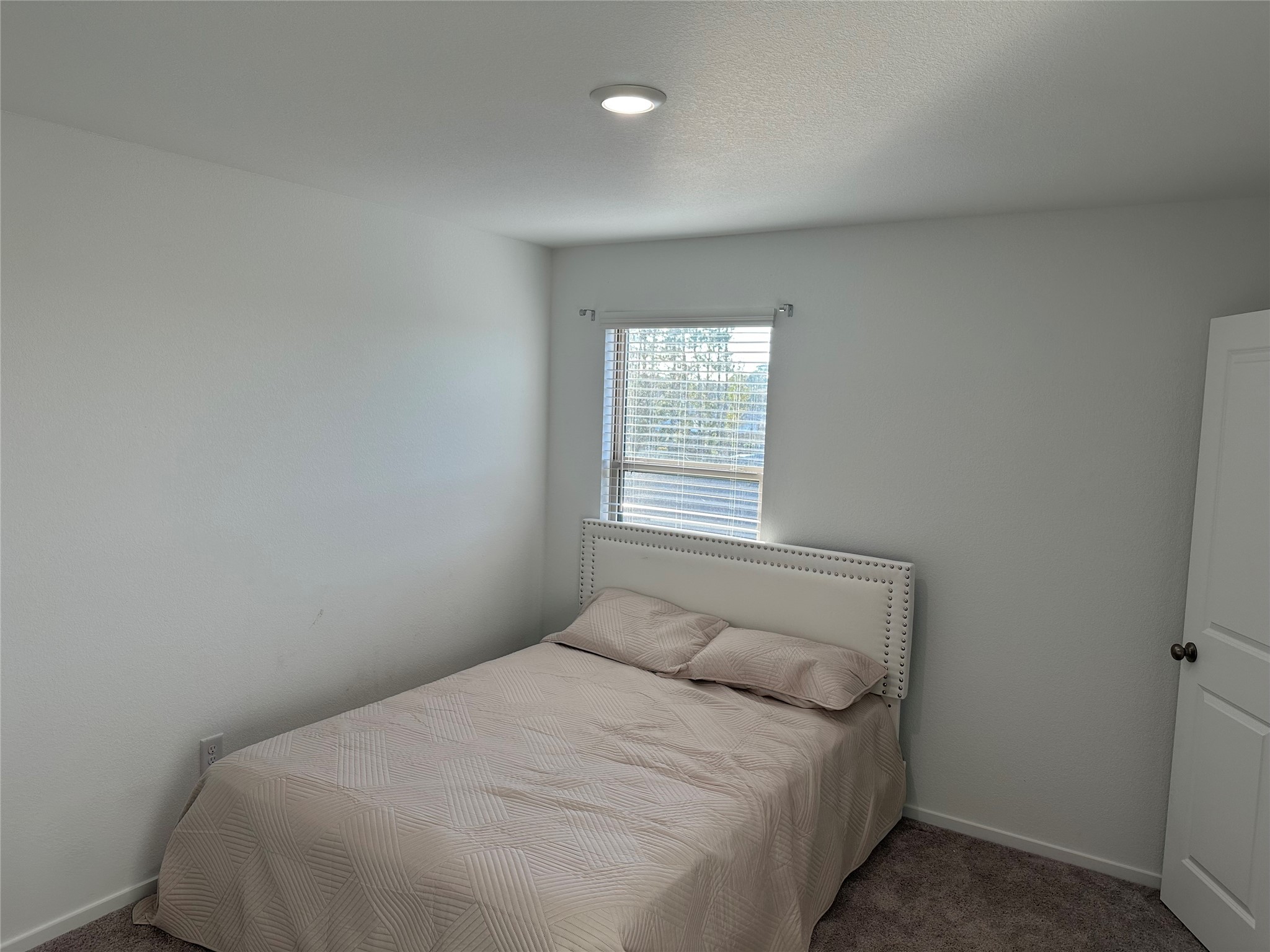 16936 Juniper Blossom Bend Conroe, TX 77302 - Photo 25 of 28 a bedroom with a bed and a window