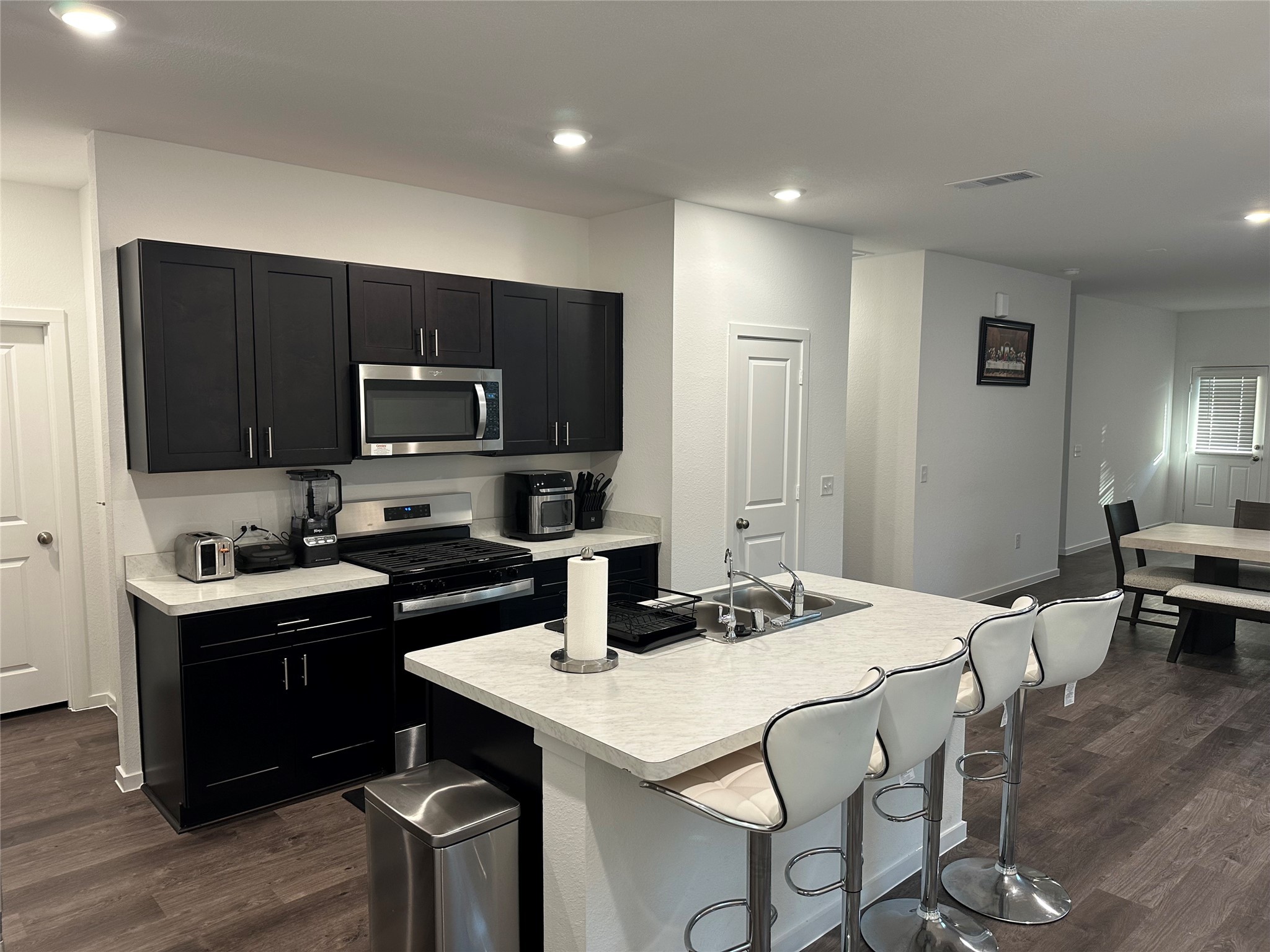 16936 Juniper Blossom Bend Conroe, TX 77302 - Photo 4 of 28 a kitchen with a stove a sink and a refrigerator