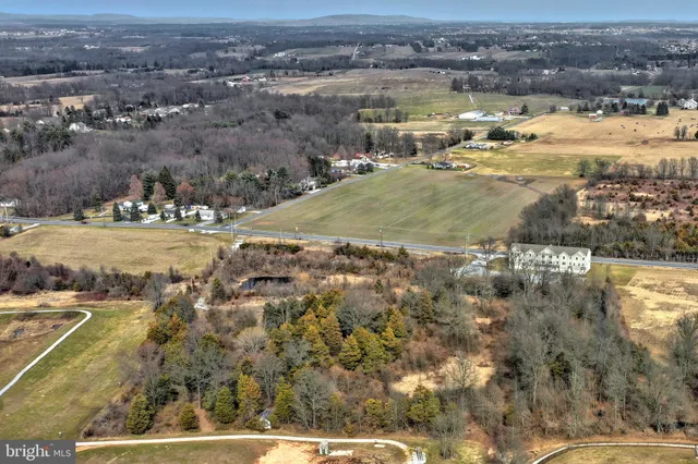 an aerial view of a houses with beach