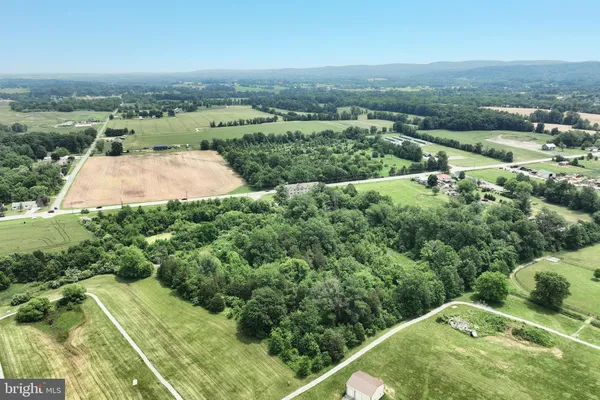 an aerial view of a house with yard