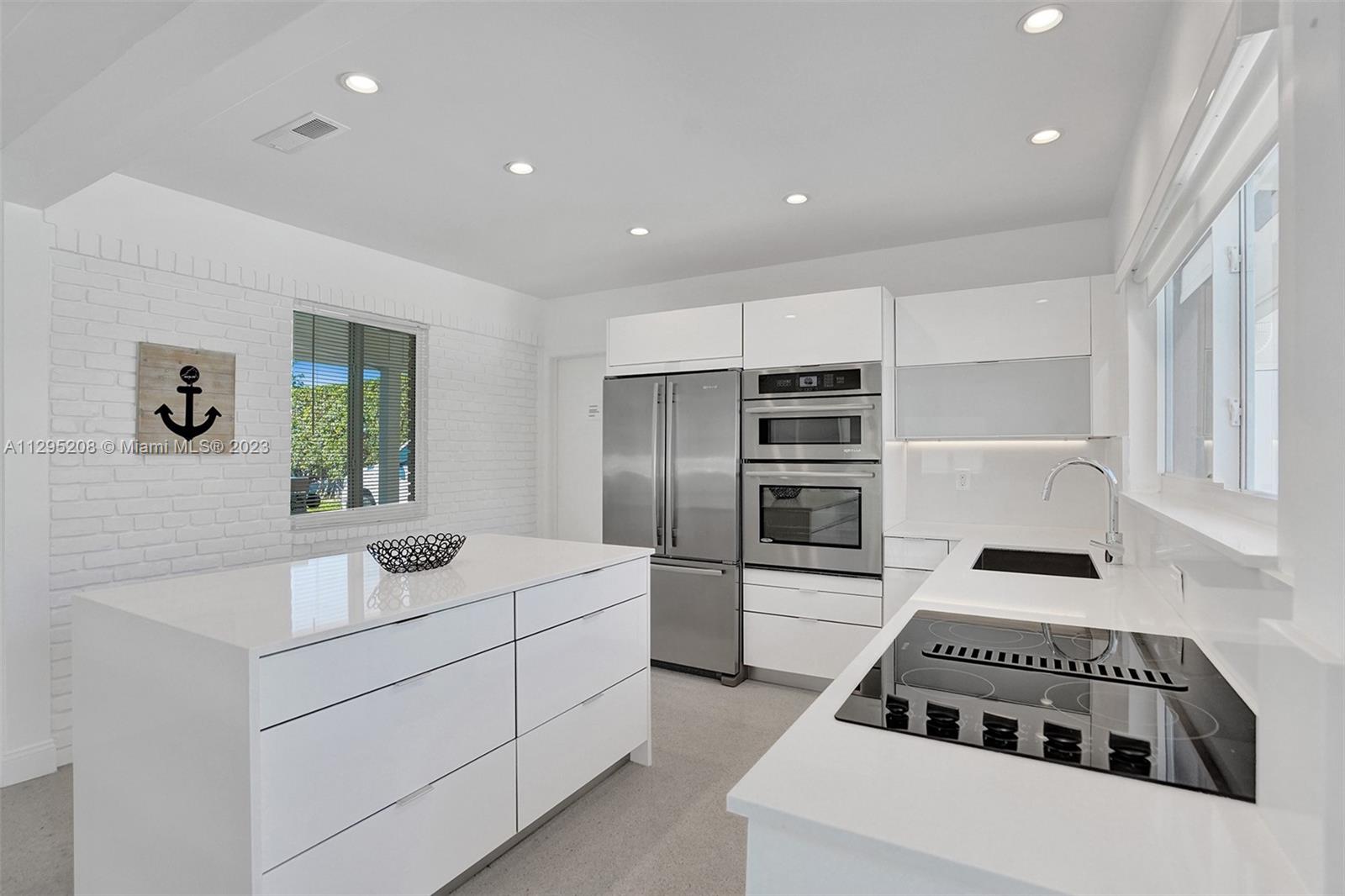 a kitchen with a sink stove and refrigerator