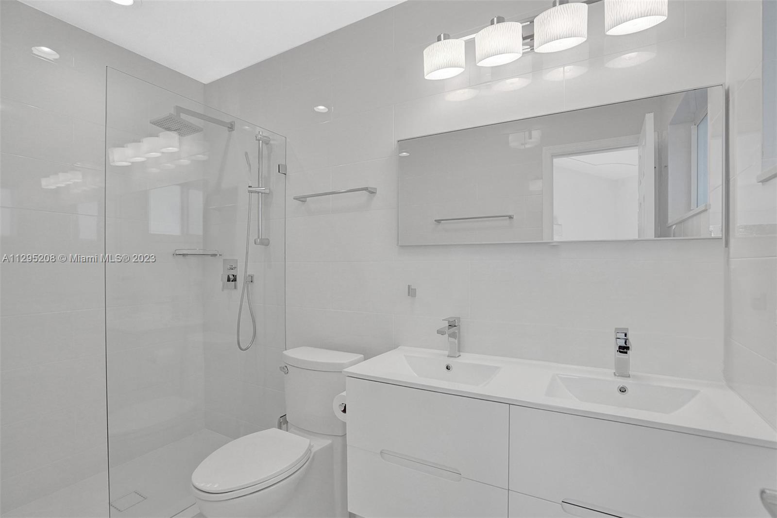 3411 Dover Road Pompano Beach, FL 33062 - Photo 24 of 64 a bathroom with a sink a toilet and mirror