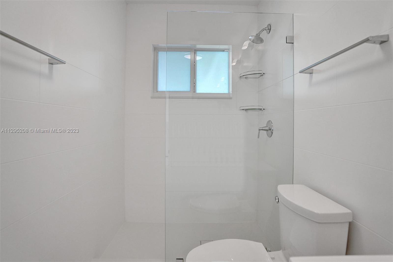 3411 Dover Road Pompano Beach, FL 33062 - Photo 30 of 64 a bathroom with a toilet and a shower