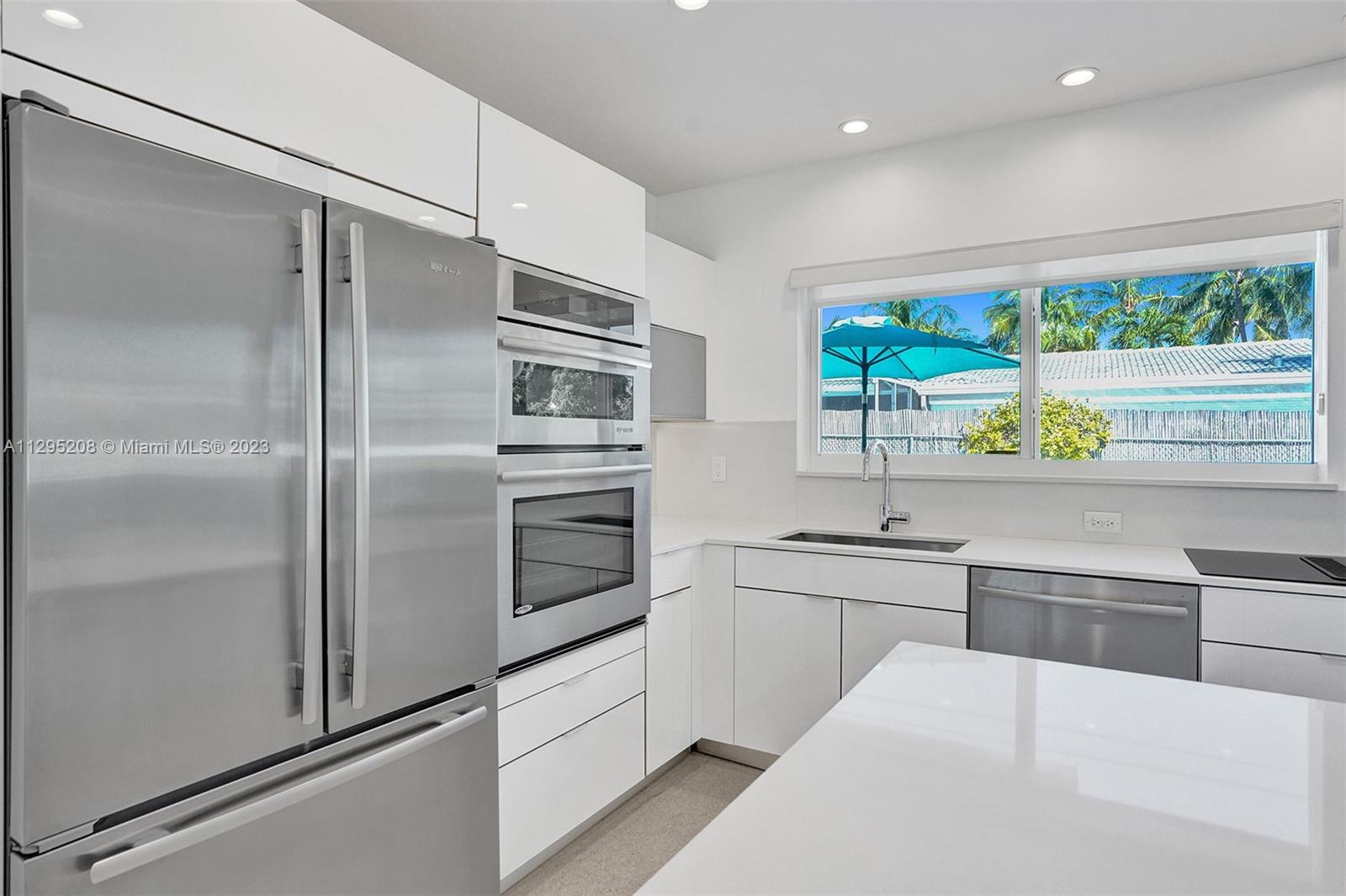 3411 Dover Road Pompano Beach, FL 33062 - Photo 8 of 64 a kitchen with stainless steel appliances a refrigerator sink and stove