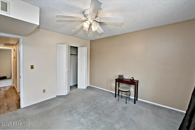 a view of room with a ceiling fan