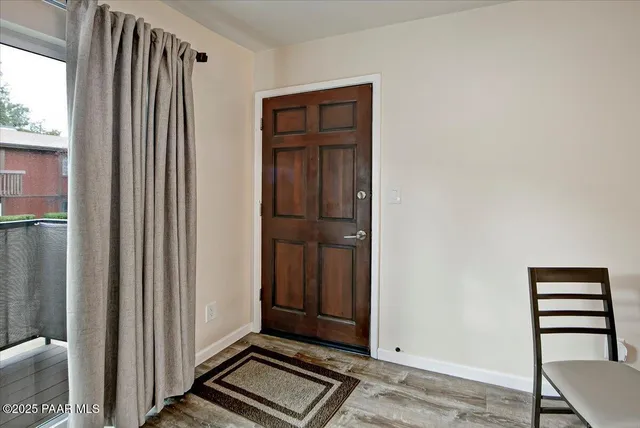 a view of front door with wooden floor
