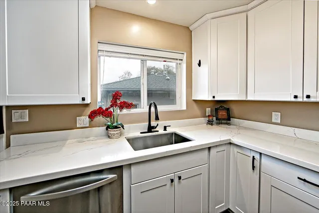 a kitchen with a sink and cabinets