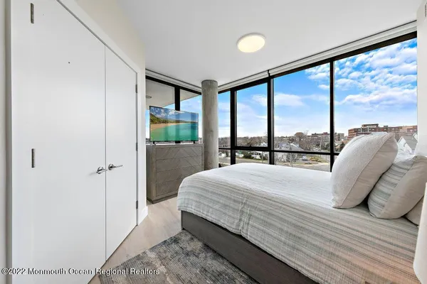 a bedroom with a bed and a painting on the wall