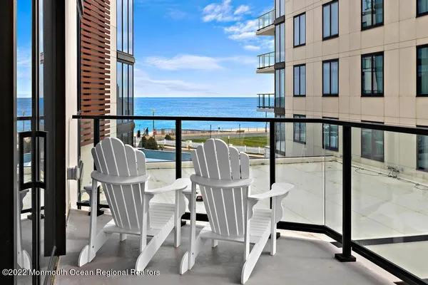 a roof deck with a couch and chairs
