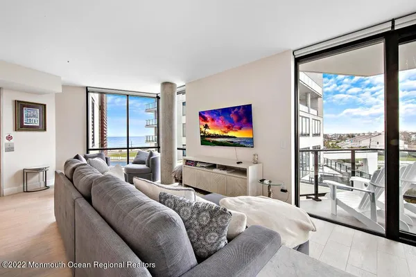 a living room with furniture next to a window