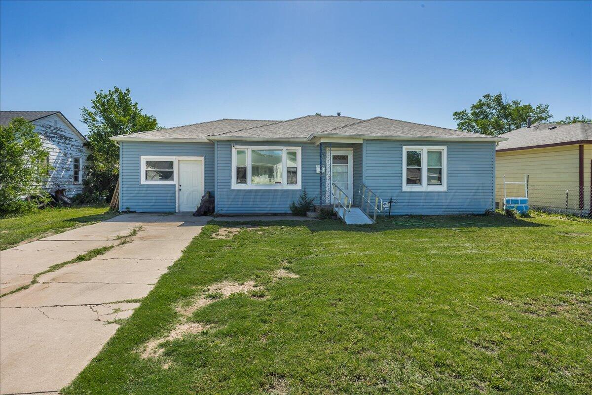 a front view of a house with a garden