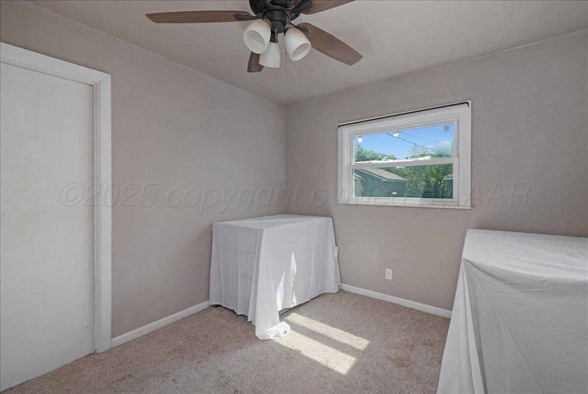 4317 Cline Road Amarillo, TX 79110 - Photo 12 of 18 a room with a fan and a window