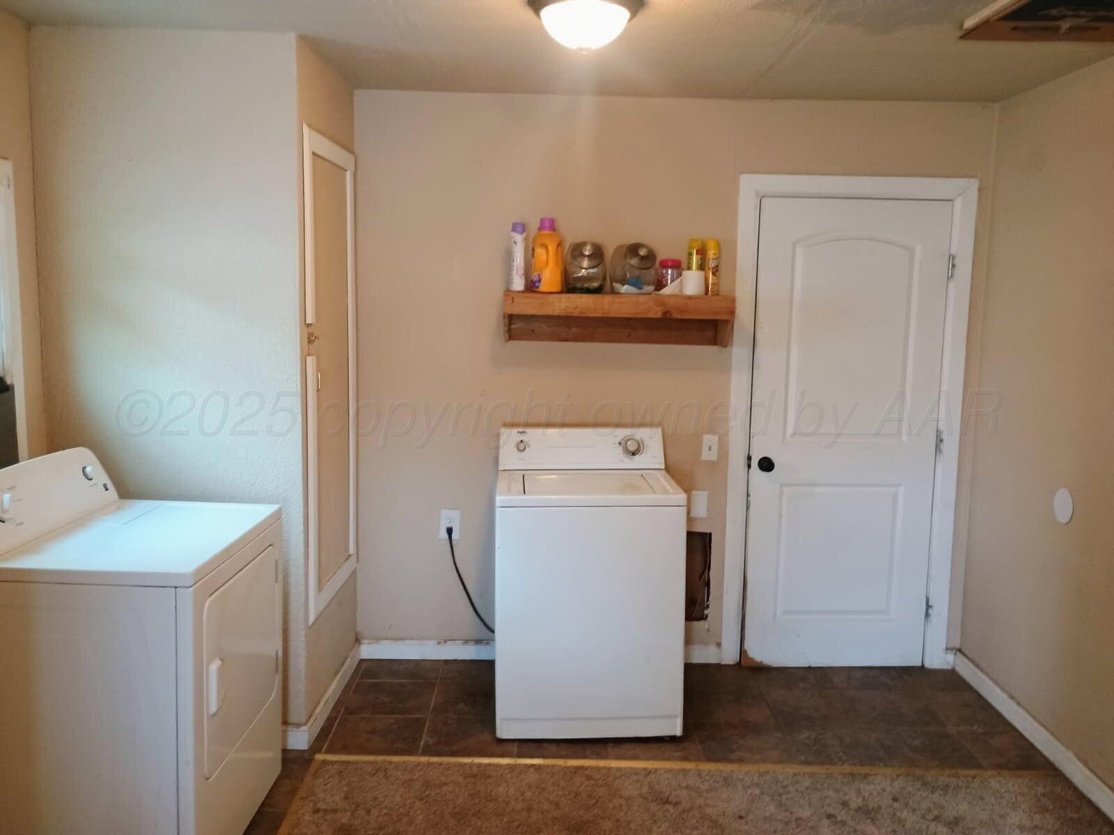4317 Cline Road Amarillo, TX 79110 - Photo 14 of 18 a utility room with dryer and washer