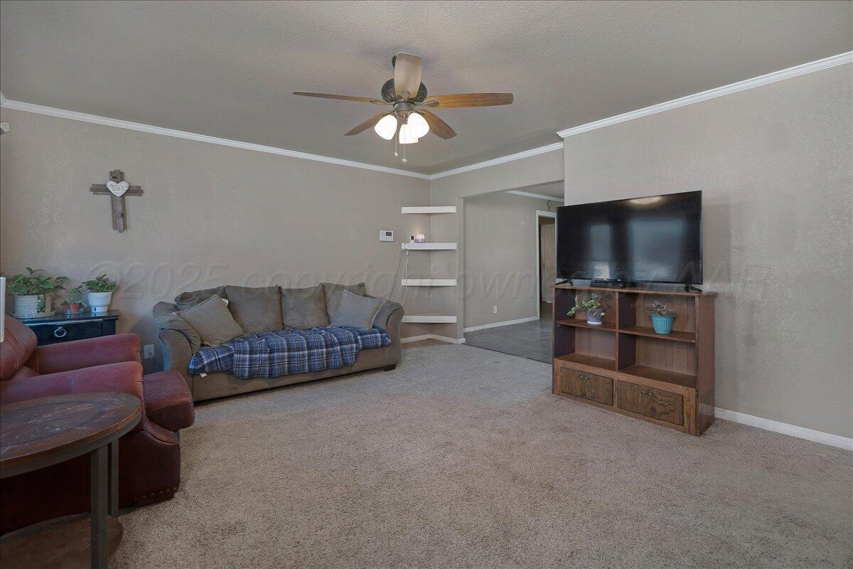 4317 Cline Road Amarillo, TX 79110 - Photo 3 of 18 a living room with furniture and a flat screen tv