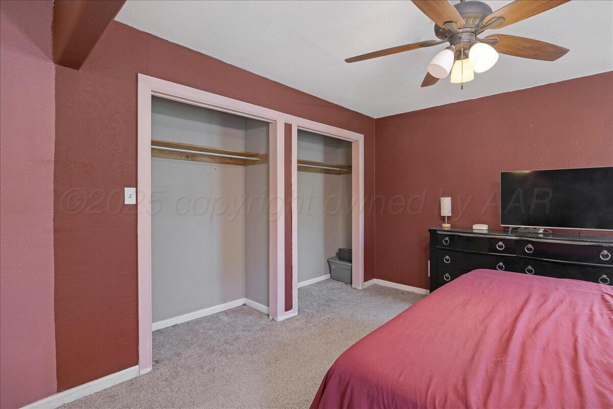 4317 Cline Road Amarillo, TX 79110 - Photo 10 of 18 a bedroom with a bed and a flat screen tv