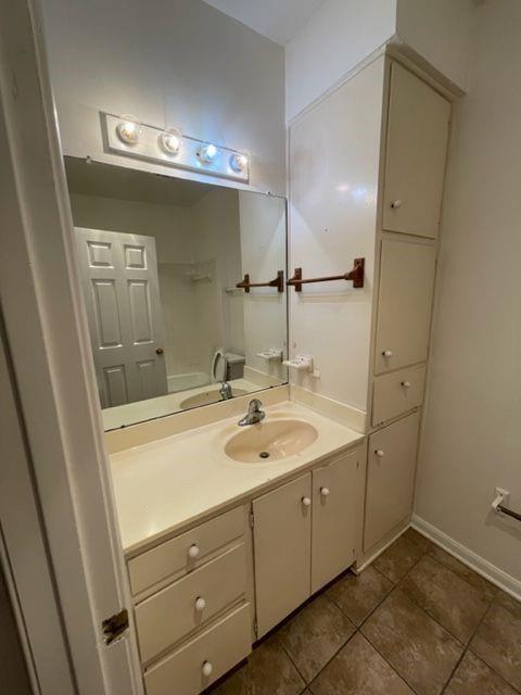 2529 Rio Grande Street, Unit 64 Austin, TX 78705 - Photo 8 of 9 Full bathroom featuring vanity, dark tile patterned floors, and a tub