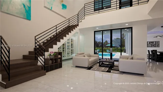 a living room with furniture and stairs to ceiling windows