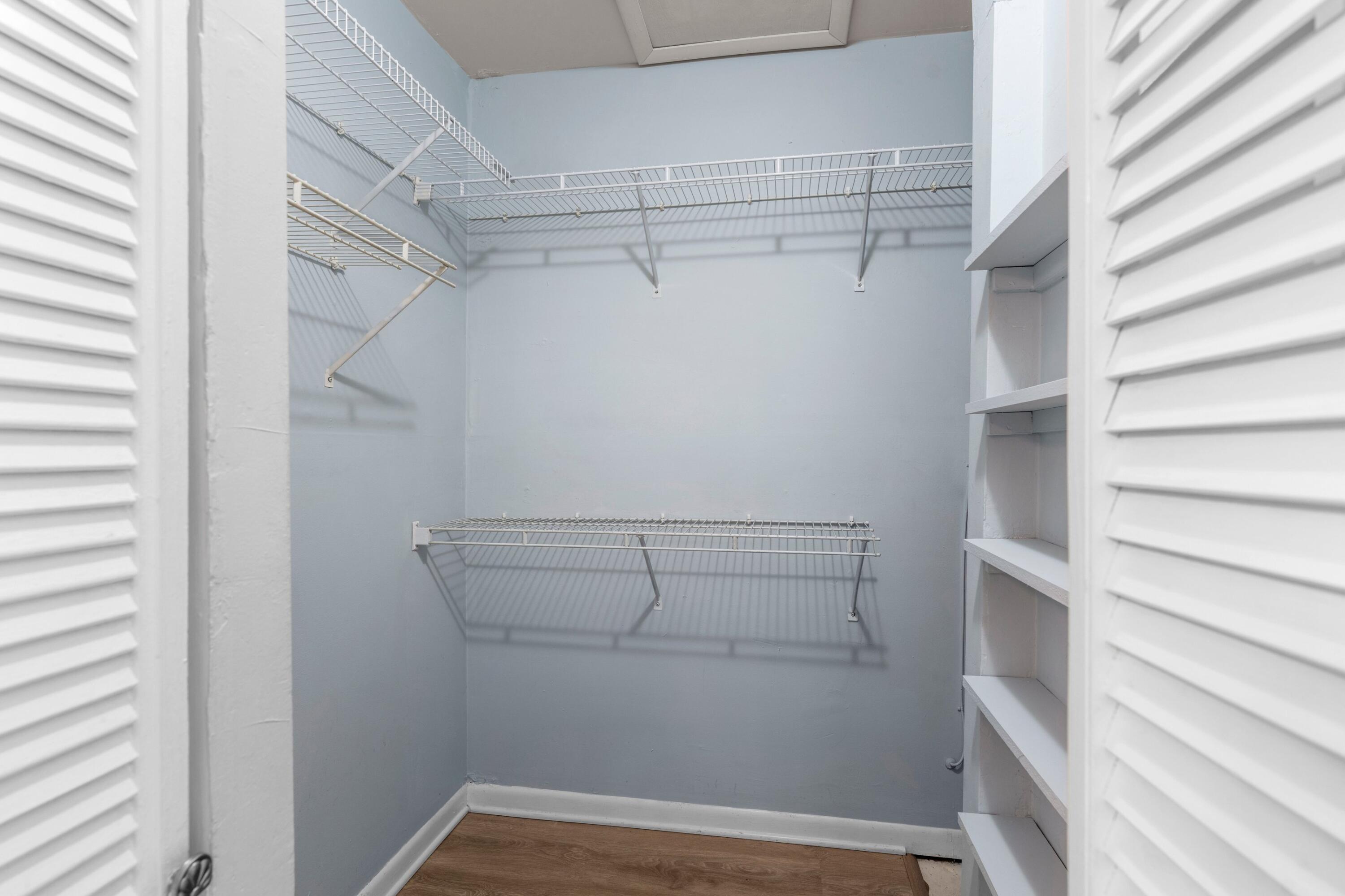 8555 Bella Vista Drive, Unit 86 Boca Raton, FL 33433 - Photo 11 of 48 a view of walk in closet with empty racks
