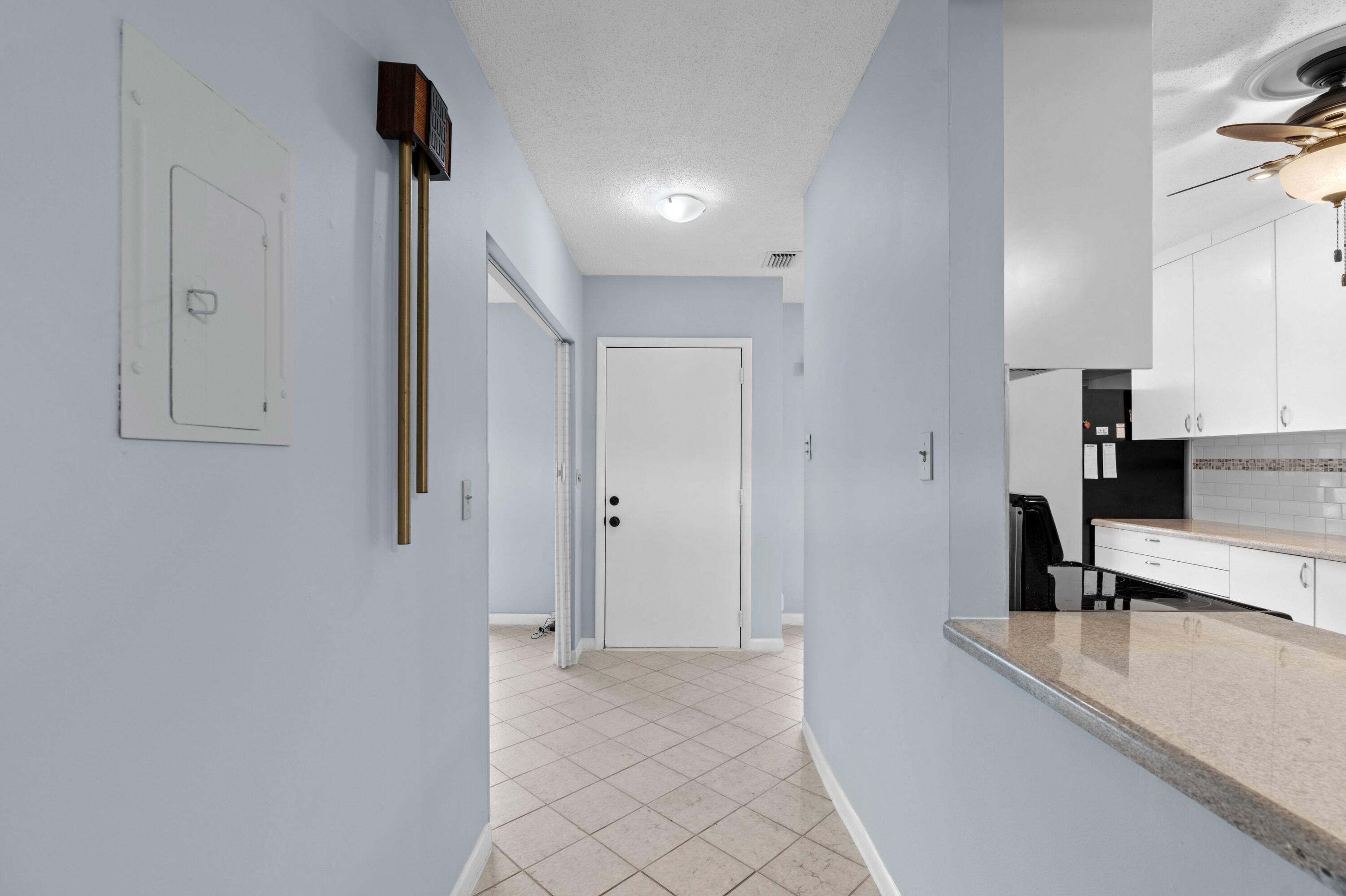 8555 Bella Vista Drive, Unit 86 Boca Raton, FL 33433 - Photo 14 of 48 a view of a kitchen with a sink and a refrigerator