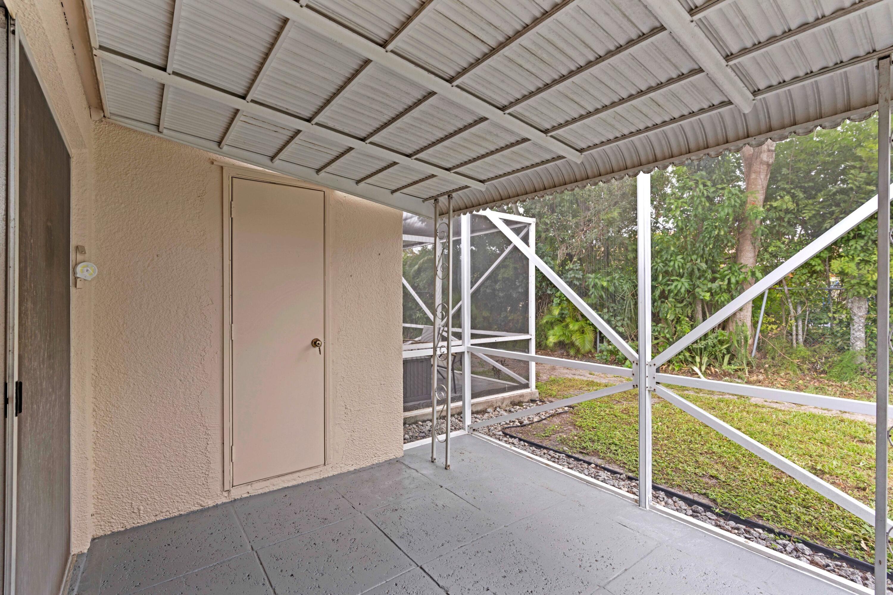 8555 Bella Vista Drive, Unit 86 Boca Raton, FL 33433 - Photo 15 of 48 a view of an empty room with floor to ceiling window