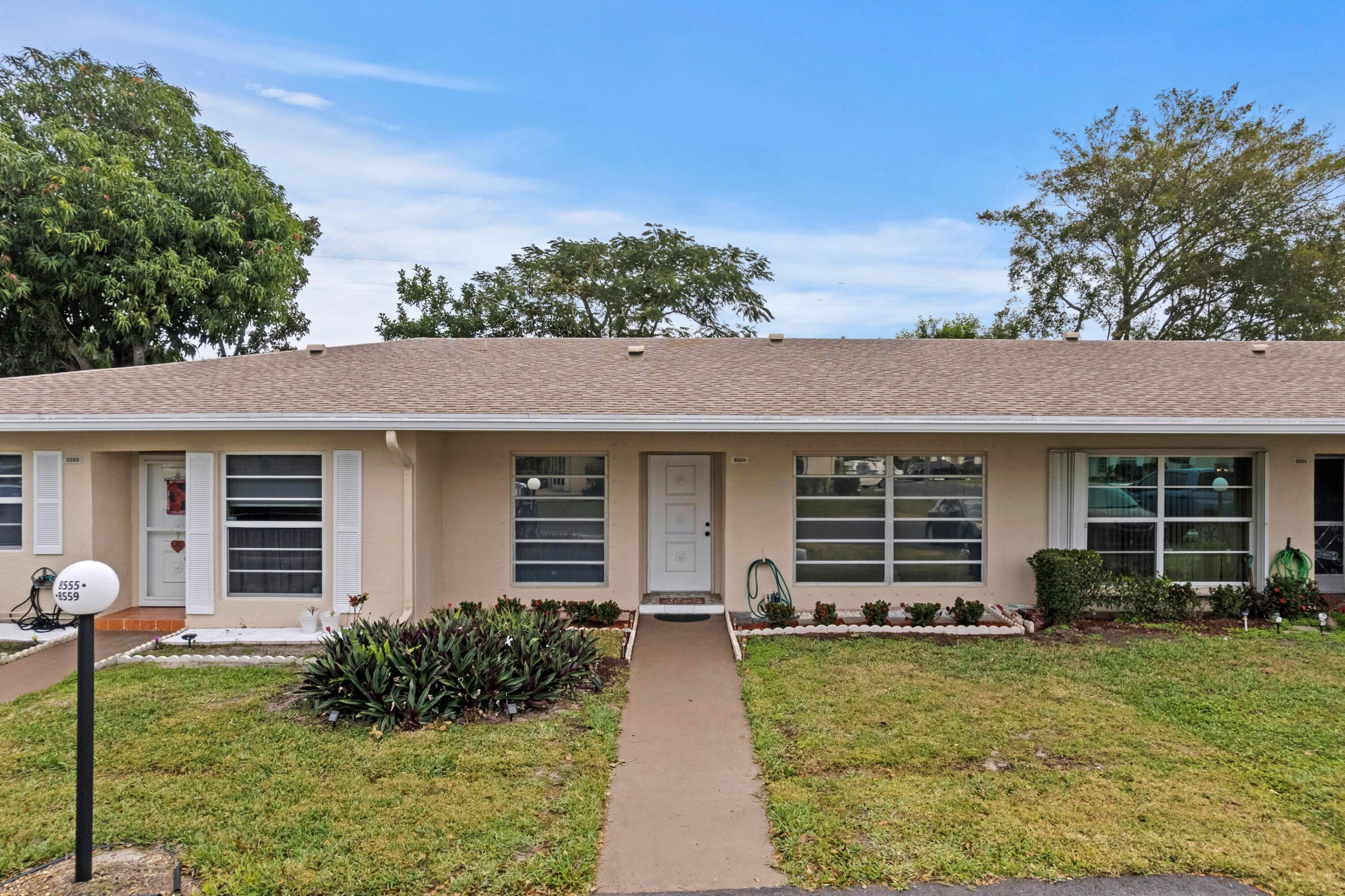 8555 Bella Vista Drive, Unit 86 Boca Raton, FL 33433 - Photo 17 of 48 front view of a house with a yard