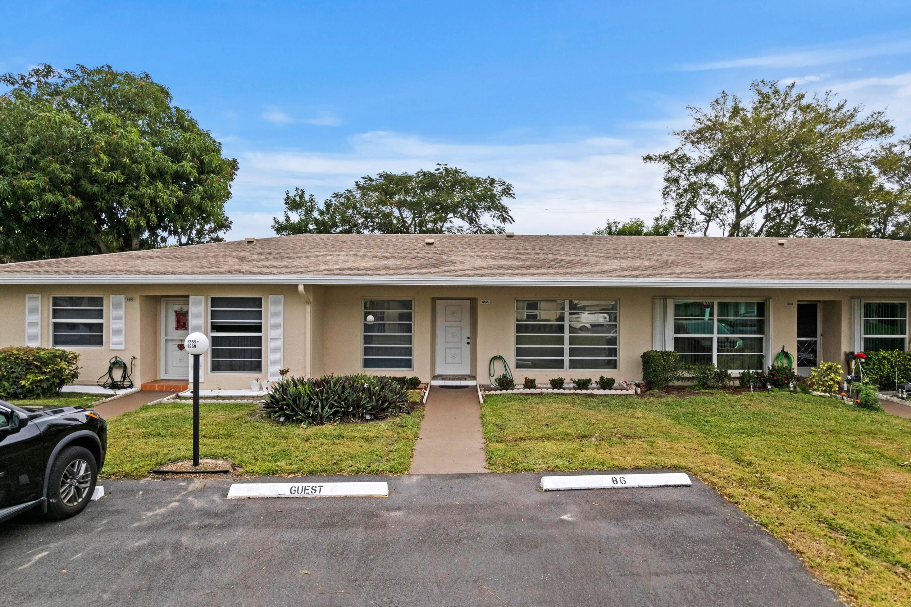 8555 Bella Vista Drive, Unit 86 Boca Raton, FL 33433 - Photo 18 of 48 front view of a house with a patio