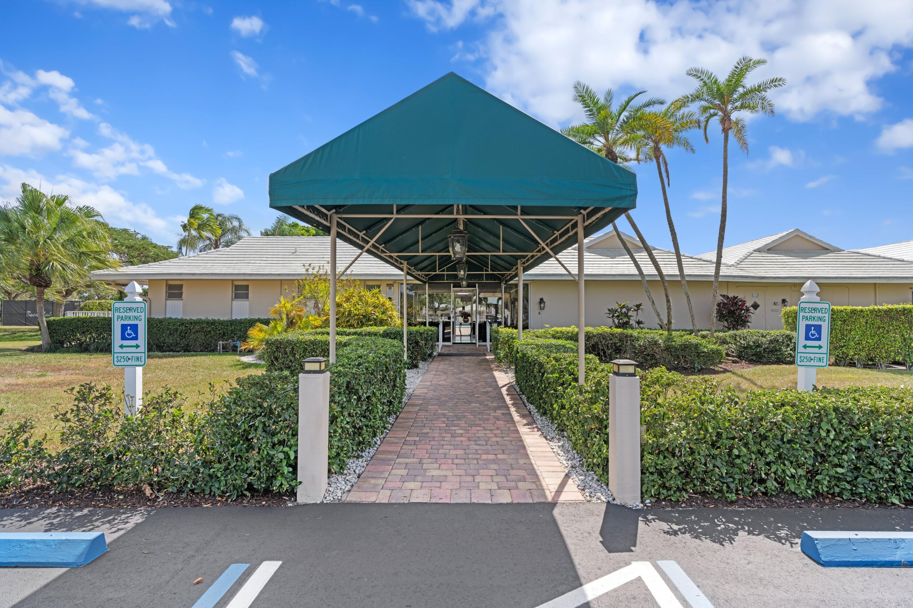 8555 Bella Vista Drive, Unit 86 Boca Raton, FL 33433 - Photo 22 of 48 a view of a house with porch and garden