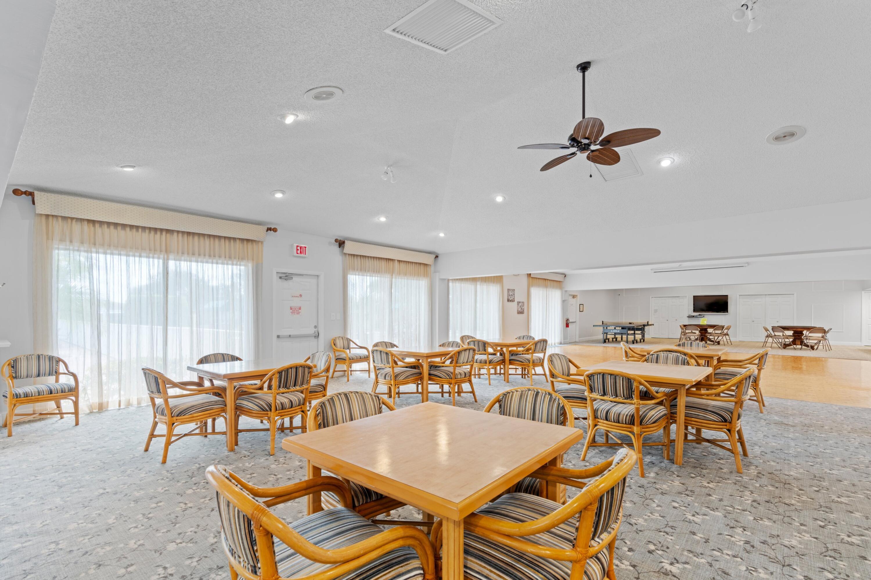 8555 Bella Vista Drive, Unit 86 Boca Raton, FL 33433 - Photo 24 of 48 a dining room with a table and chairs