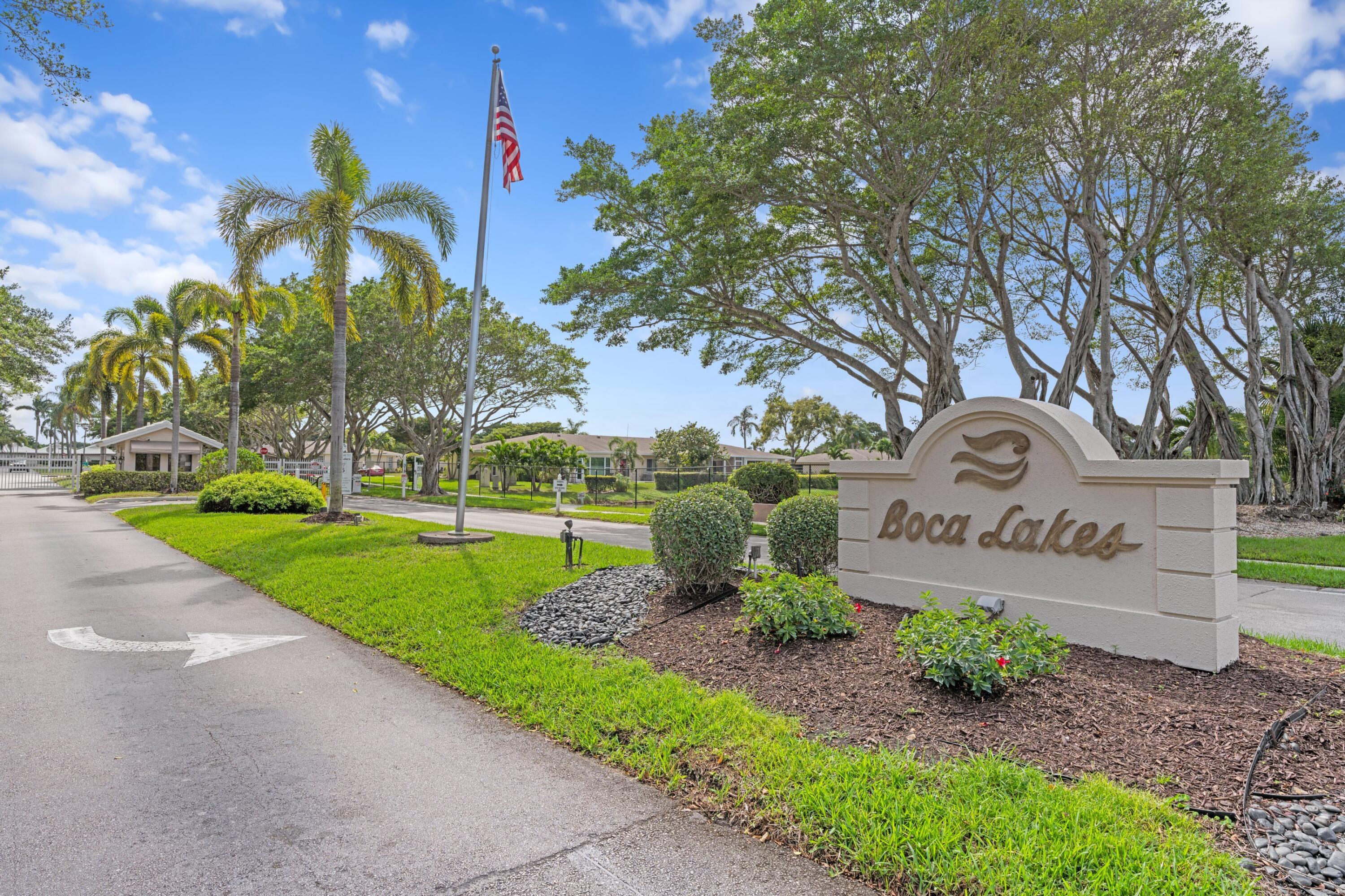8555 Bella Vista Drive, Unit 86 Boca Raton, FL 33433 - Photo 47 of 48 a front view of a house with garden and trees