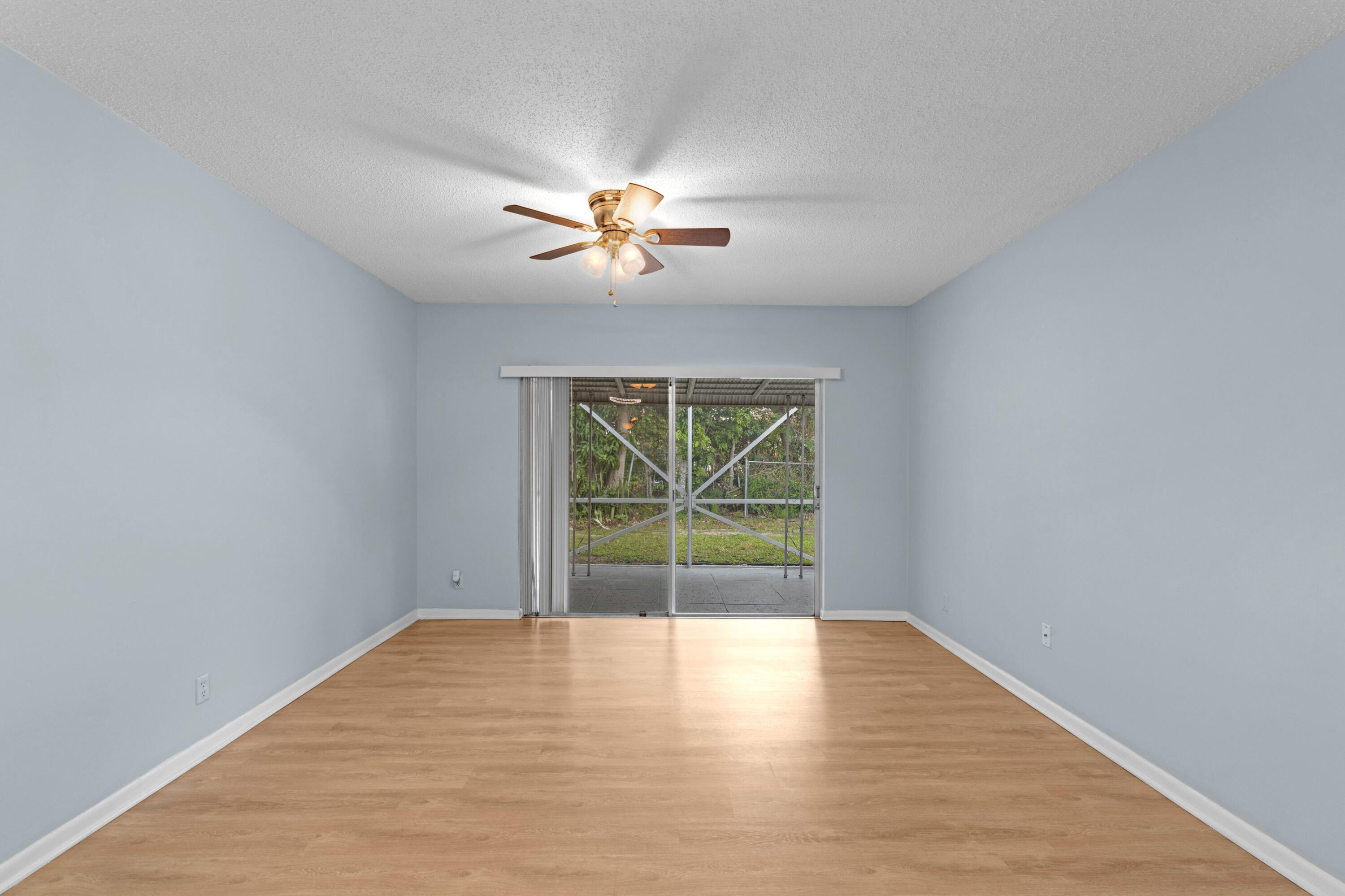 8555 Bella Vista Drive, Unit 86 Boca Raton, FL 33433 - Photo 6 of 48 wooden floor in an empty room with a window