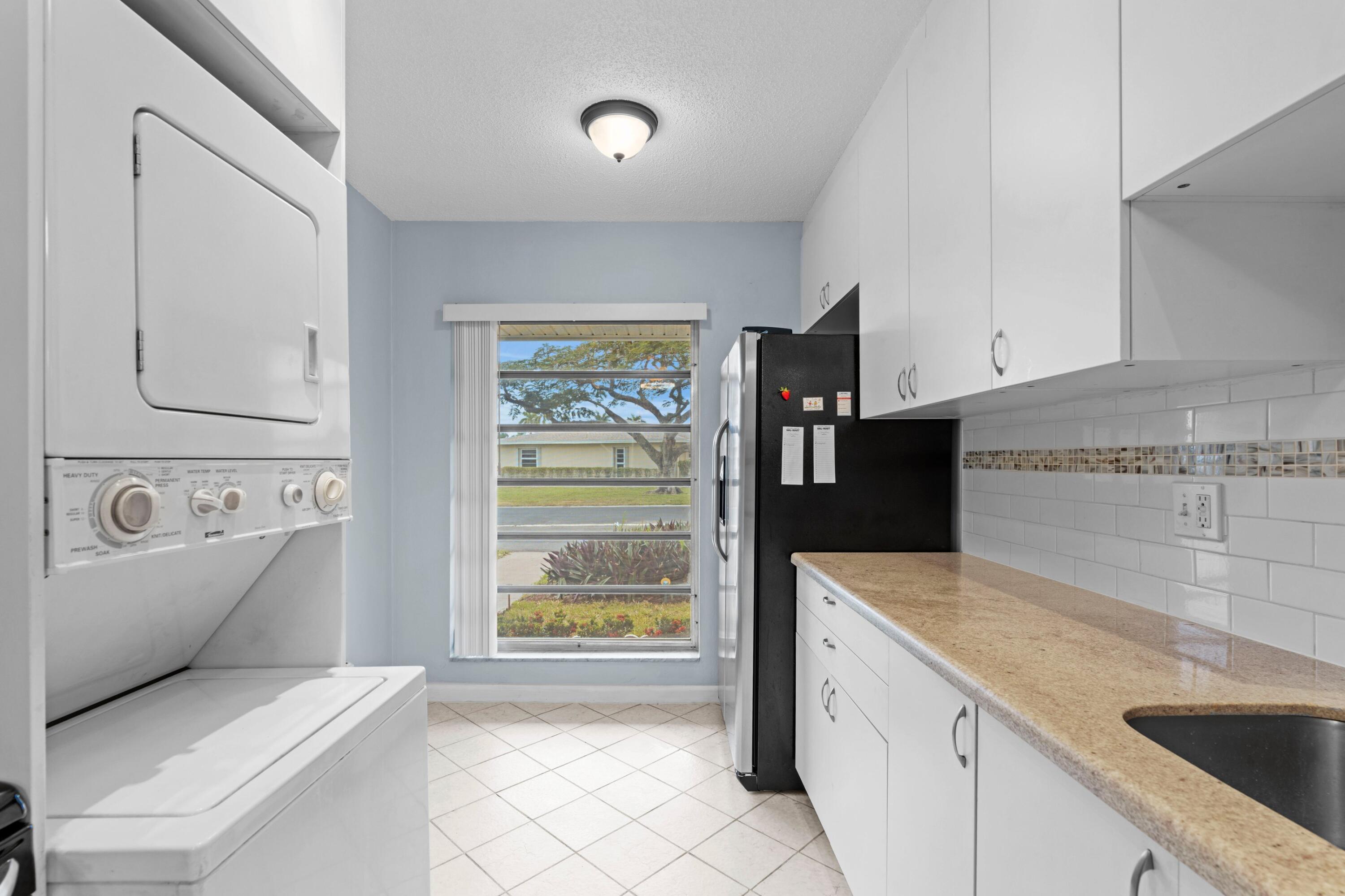 8555 Bella Vista Drive, Unit 86 Boca Raton, FL 33433 - Photo 7 of 48 a kitchen with a refrigerator and a sink
