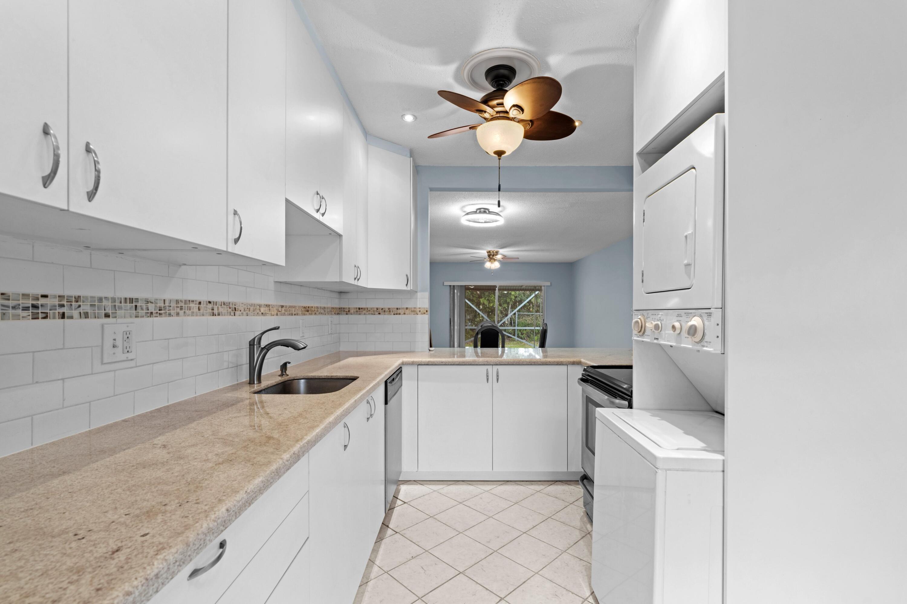 8555 Bella Vista Drive, Unit 86 Boca Raton, FL 33433 - Photo 9 of 48 a kitchen with a sink appliances and cabinets