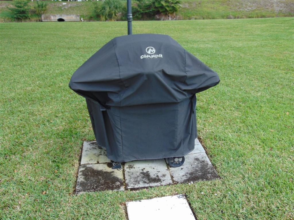 9788 Marina Boulevard, Unit 313 Boca Raton, FL 33428 - Photo 14 of 70 a view of a backyard with table and chairs