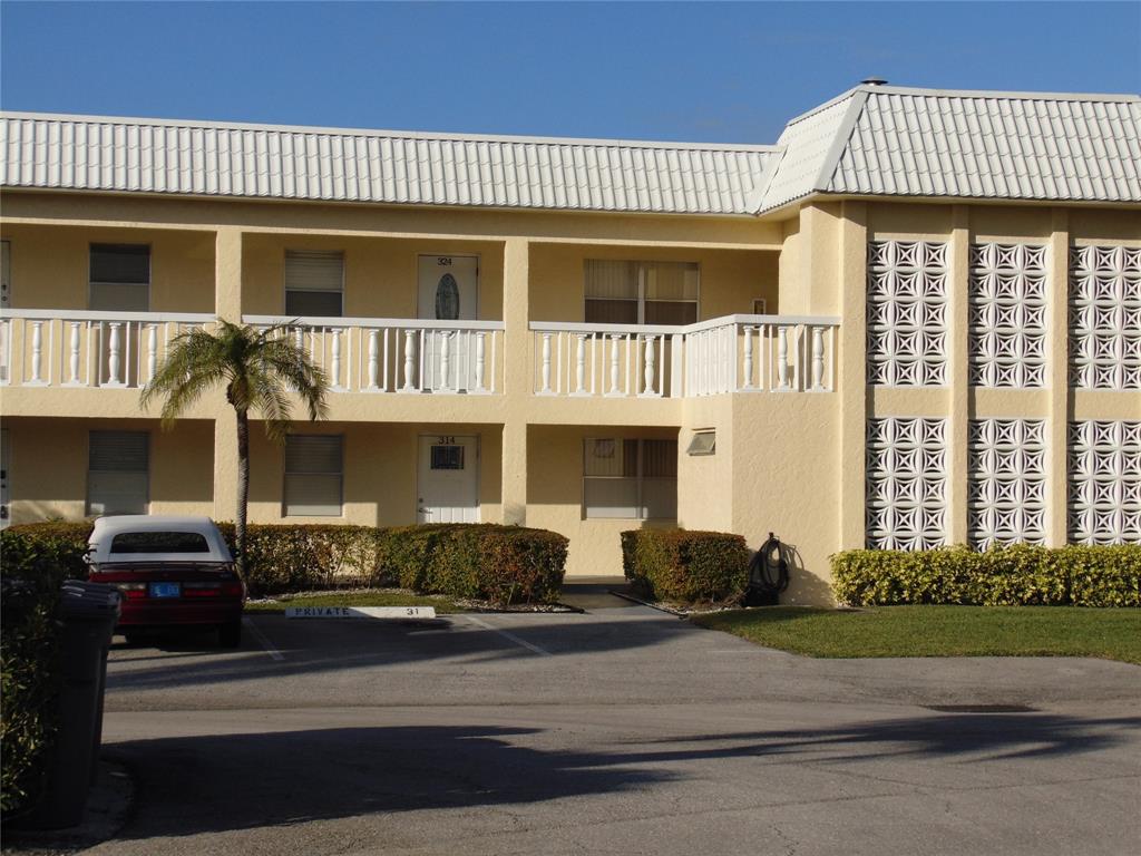 9788 Marina Boulevard, Unit 313 Boca Raton, FL 33428 - Photo 20 of 70 a front view of a house with a garden