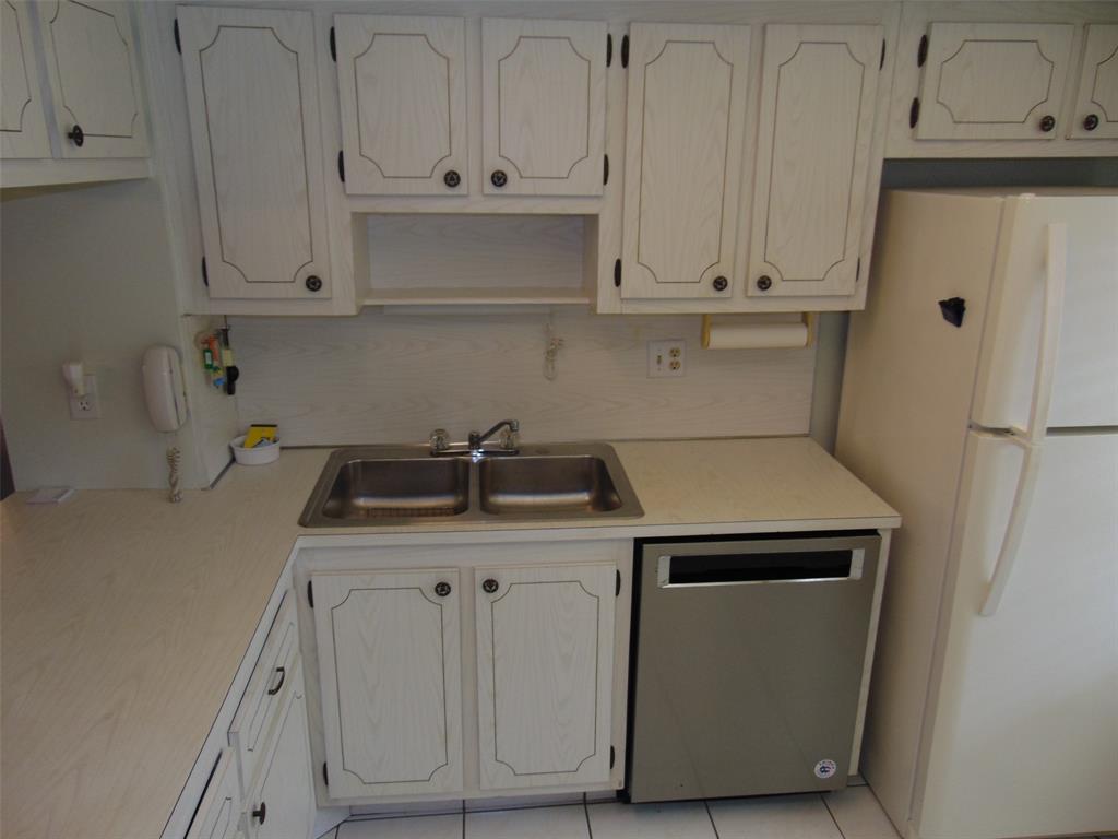 9788 Marina Boulevard, Unit 313 Boca Raton, FL 33428 - Photo 23 of 70 a utility room with stainless steel appliances white cabinets and a sink