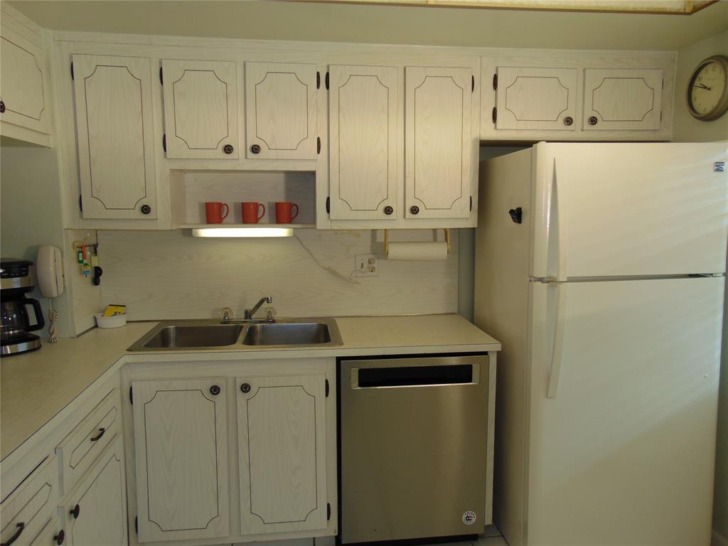9788 Marina Boulevard, Unit 313 Boca Raton, FL 33428 - Photo 56 of 70 a kitchen with stainless steel appliances white cabinets and a refrigerator