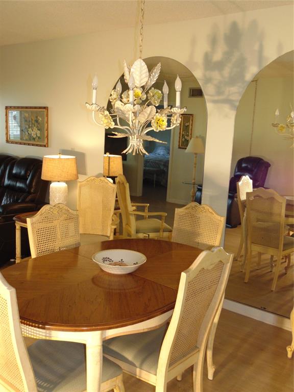 9788 Marina Boulevard, Unit 313 Boca Raton, FL 33428 - Photo 70 of 70 a dining room with furniture and wooden floor