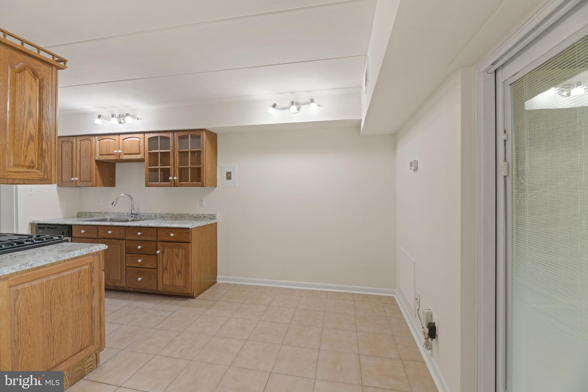 2326 Freetown Court, Unit 2B Reston, VA 20191 - Photo 14 of 21 Spacious kitchen with warm wooden accents.