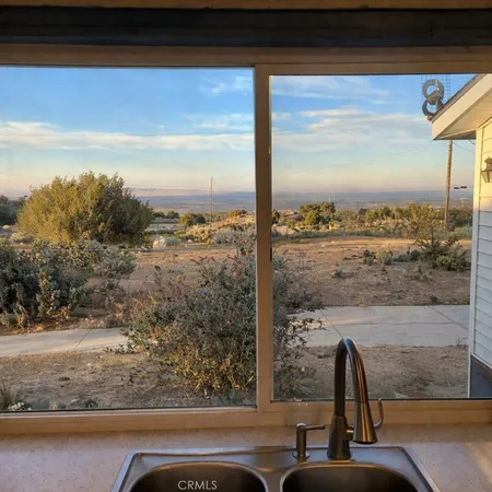 a bedroom with a bed a table and chair