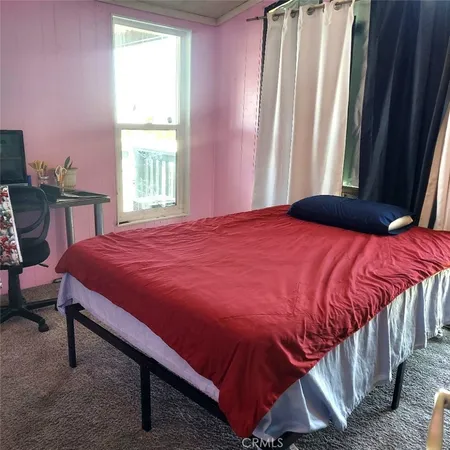 a bedroom with a bed and a book shelf