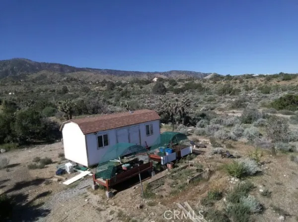 a view of a chairs with roof and wooden fence