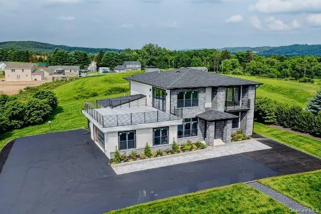 an aerial view of a house with a yard table and chairs