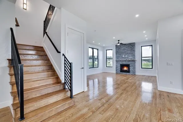 a view of empty room with wooden floor and fireplace
