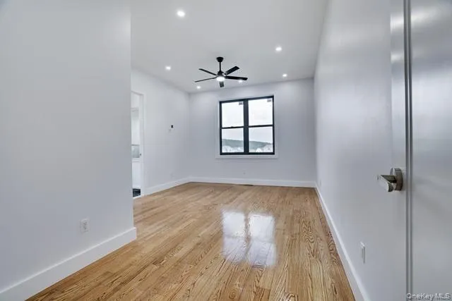 wooden floor in an empty room with a window
