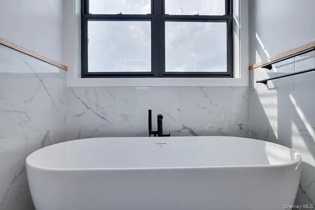 a white bath tub sitting next to a window