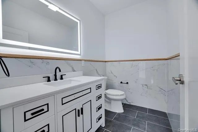 a bathroom with a sink toilet and vanity