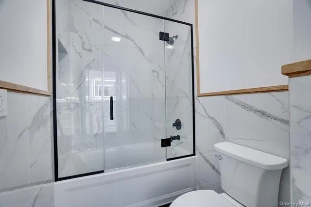 a bathroom with a toilet and a shower